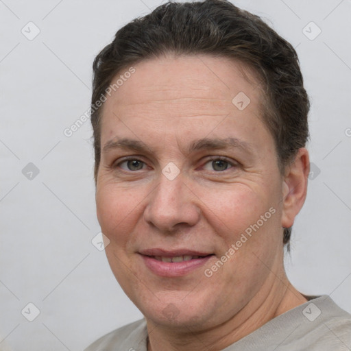 Joyful white adult female with short  brown hair and brown eyes