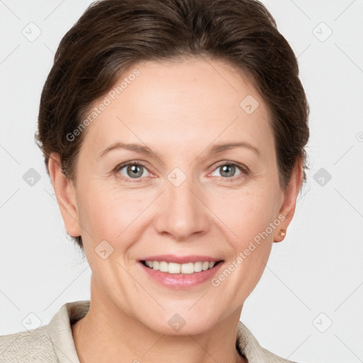 Joyful white adult female with short  brown hair and grey eyes