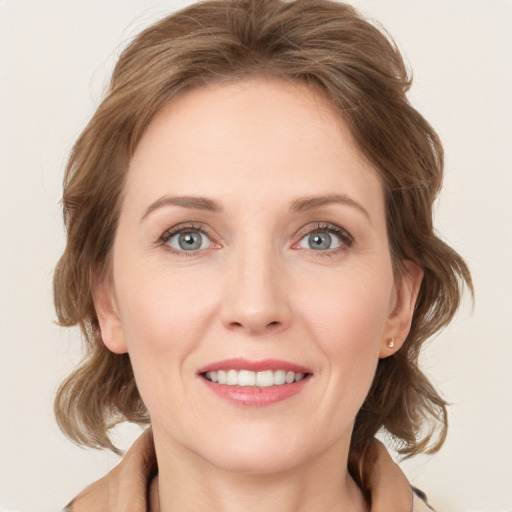 Joyful white young-adult female with medium  brown hair and green eyes