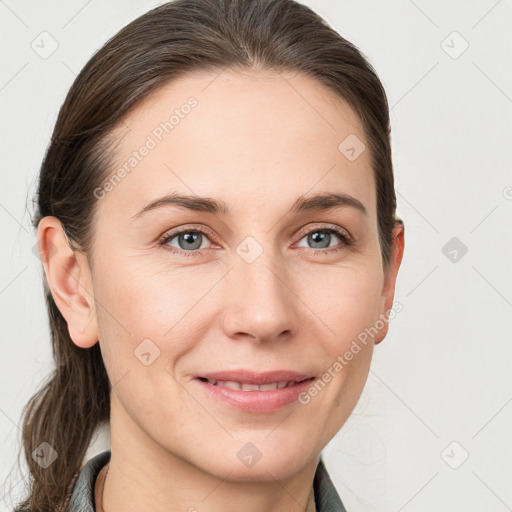 Joyful white young-adult female with medium  brown hair and grey eyes