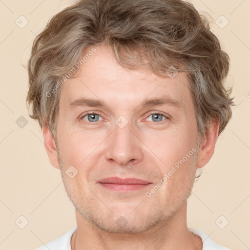 Joyful white adult male with short  brown hair and grey eyes