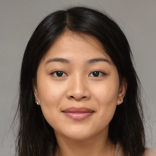 Joyful asian young-adult female with long  brown hair and brown eyes
