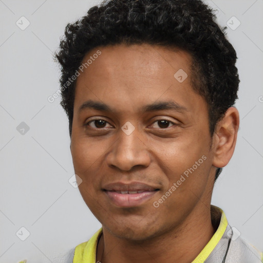 Joyful black young-adult male with short  black hair and brown eyes