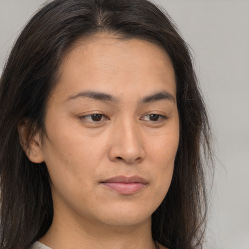 Joyful asian young-adult female with long  brown hair and brown eyes