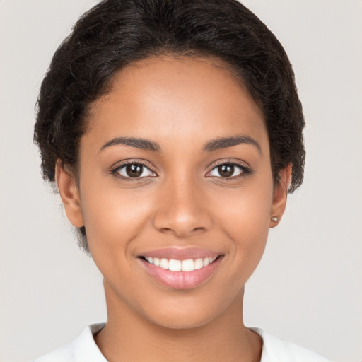 Joyful latino young-adult female with short  brown hair and brown eyes