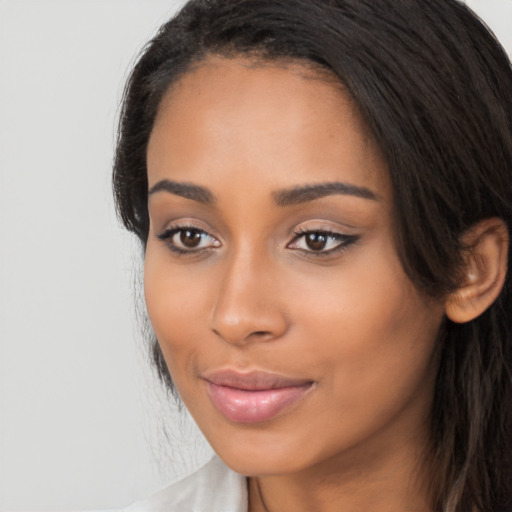 Joyful latino young-adult female with long  black hair and brown eyes