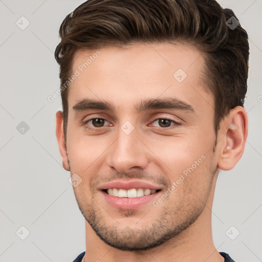 Joyful white young-adult male with short  brown hair and brown eyes