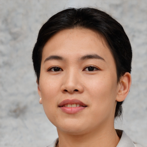 Joyful asian young-adult female with short  black hair and brown eyes