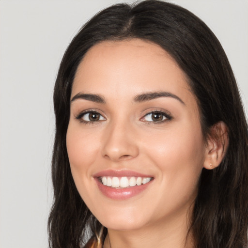 Joyful white young-adult female with long  black hair and brown eyes