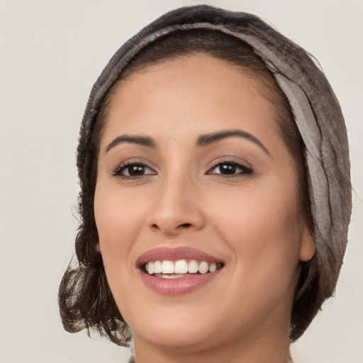 Joyful white young-adult female with long  brown hair and brown eyes