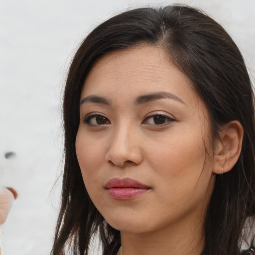 Joyful asian young-adult female with long  brown hair and brown eyes