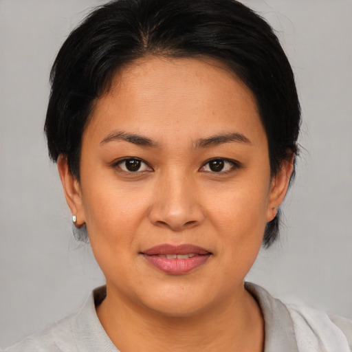 Joyful asian young-adult female with medium  black hair and brown eyes