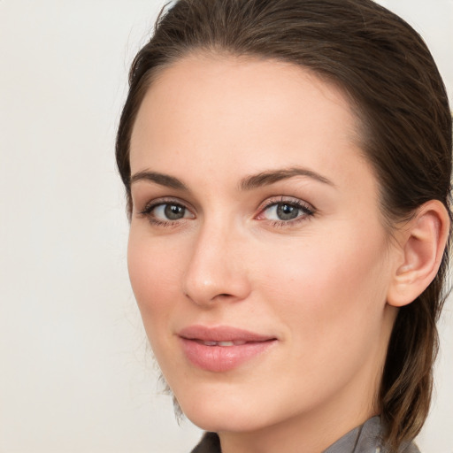 Joyful white young-adult female with long  brown hair and blue eyes