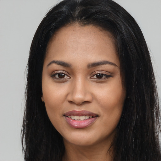 Joyful latino young-adult female with long  brown hair and brown eyes