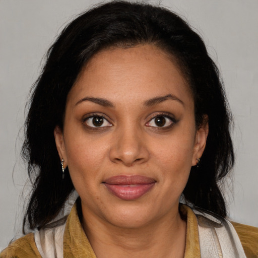 Joyful latino young-adult female with medium  brown hair and brown eyes