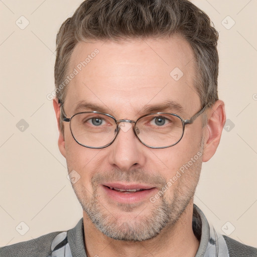 Joyful white adult male with short  brown hair and grey eyes