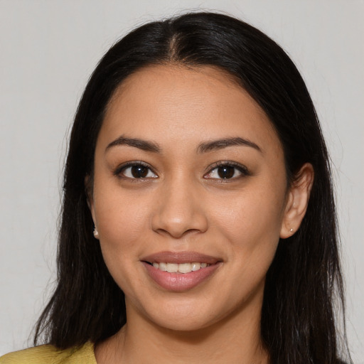 Joyful latino young-adult female with long  brown hair and brown eyes
