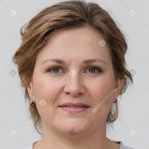 Joyful white adult female with medium  brown hair and grey eyes