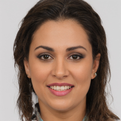 Joyful white young-adult female with long  brown hair and brown eyes