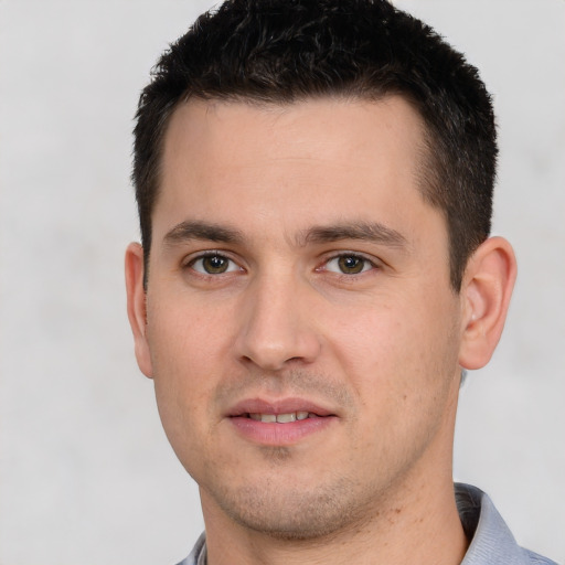 Joyful white young-adult male with short  black hair and brown eyes