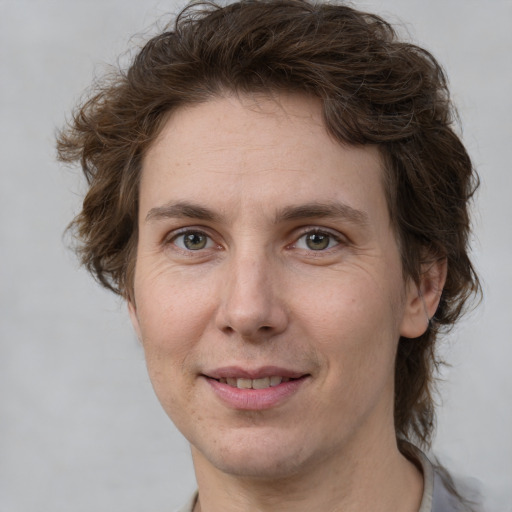 Joyful white adult female with medium  brown hair and grey eyes