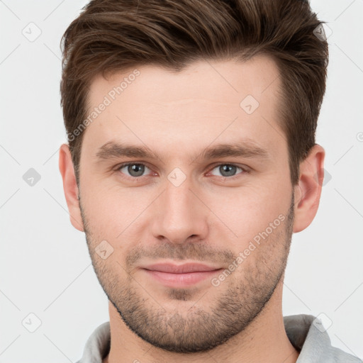 Joyful white young-adult male with short  brown hair and grey eyes