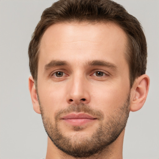 Joyful white young-adult male with short  brown hair and brown eyes