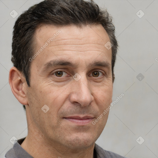 Joyful white adult male with short  brown hair and brown eyes