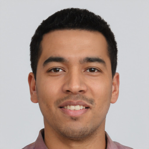 Joyful latino young-adult male with short  black hair and brown eyes