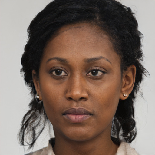 Neutral black young-adult female with medium  brown hair and brown eyes
