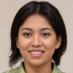 Joyful asian young-adult female with medium  brown hair and brown eyes