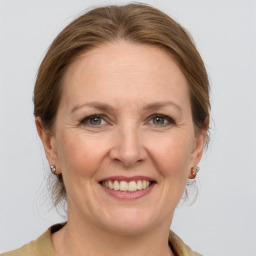 Joyful white adult female with medium  brown hair and grey eyes