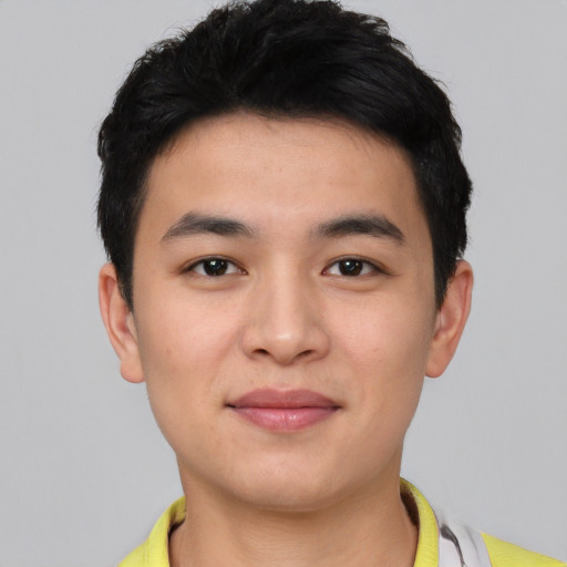 Joyful asian young-adult male with short  black hair and brown eyes
