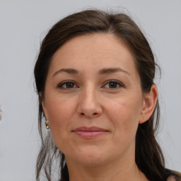 Joyful white adult female with medium  brown hair and brown eyes