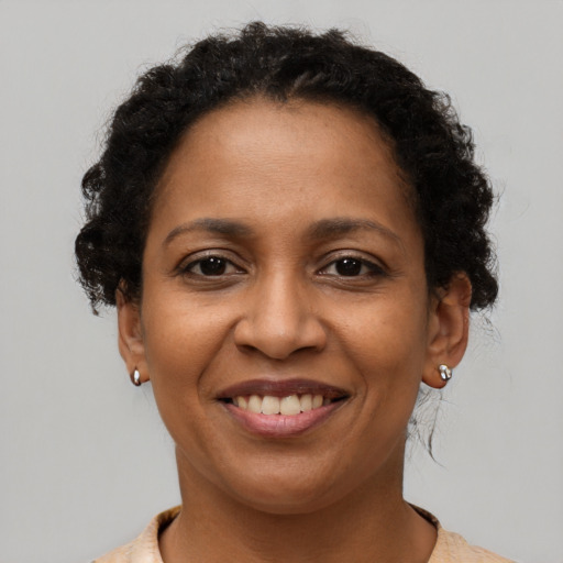 Joyful latino adult female with short  brown hair and brown eyes
