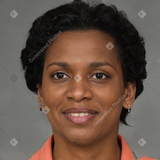 Joyful black adult female with short  brown hair and brown eyes