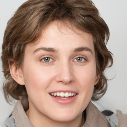 Joyful white young-adult female with medium  brown hair and green eyes