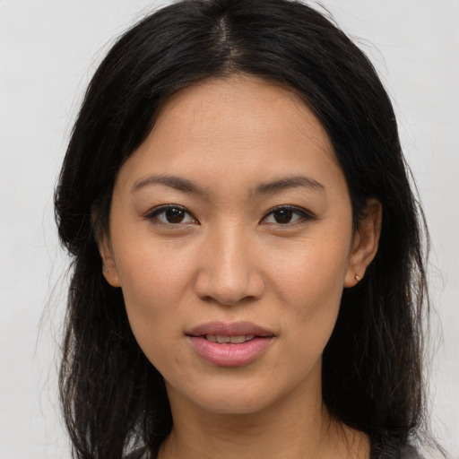 Joyful asian young-adult female with long  brown hair and brown eyes