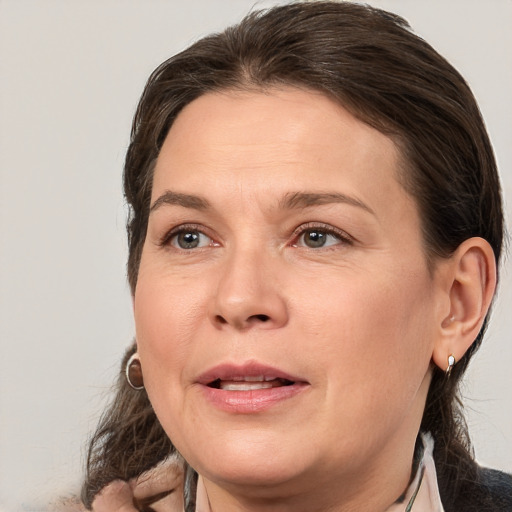 Joyful white adult female with medium  brown hair and brown eyes