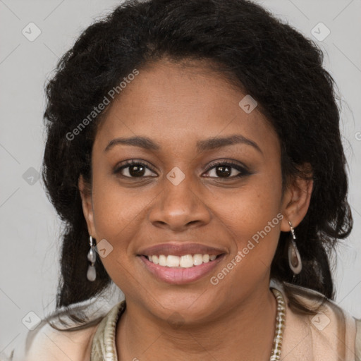 Joyful black young-adult female with long  brown hair and brown eyes