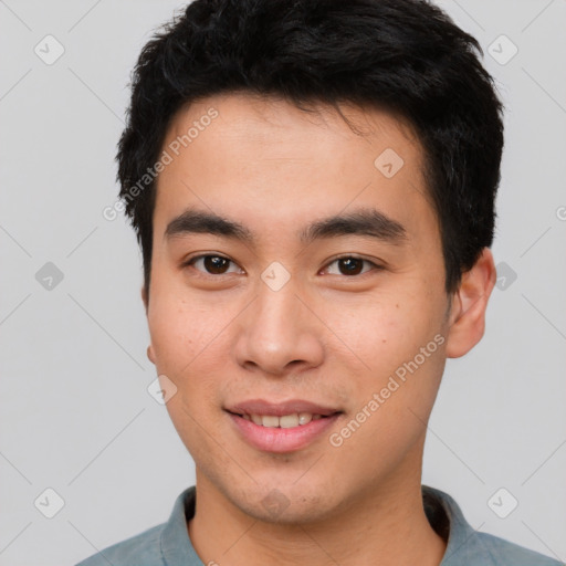 Joyful asian young-adult male with short  black hair and brown eyes