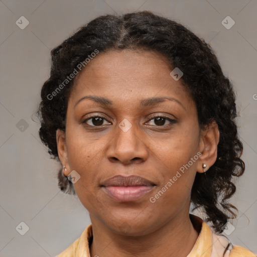 Joyful black adult female with medium  brown hair and brown eyes