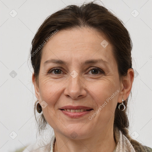 Joyful white adult female with medium  brown hair and brown eyes