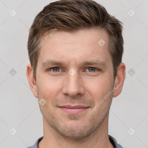 Joyful white adult male with short  brown hair and grey eyes