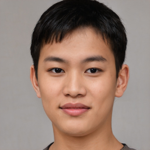 Joyful asian young-adult male with short  black hair and brown eyes