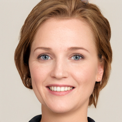 Joyful white young-adult female with medium  brown hair and blue eyes