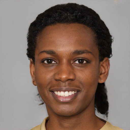 Joyful black young-adult female with short  black hair and brown eyes