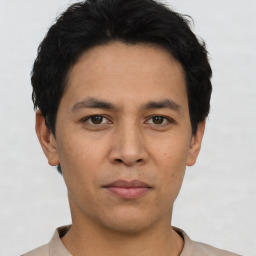 Joyful asian young-adult male with short  black hair and brown eyes