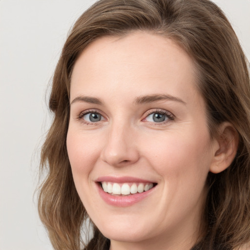 Joyful white young-adult female with medium  brown hair and blue eyes