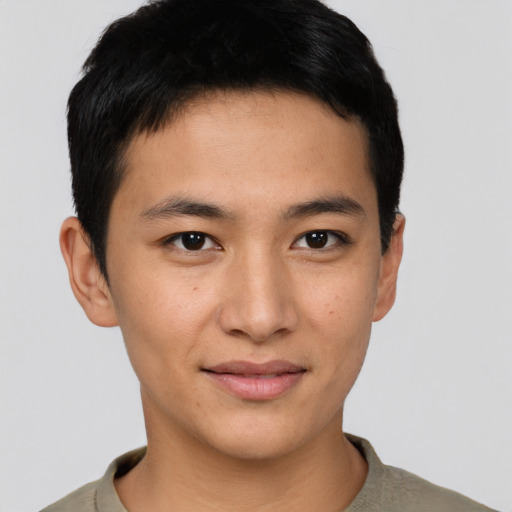 Joyful asian young-adult male with short  black hair and brown eyes